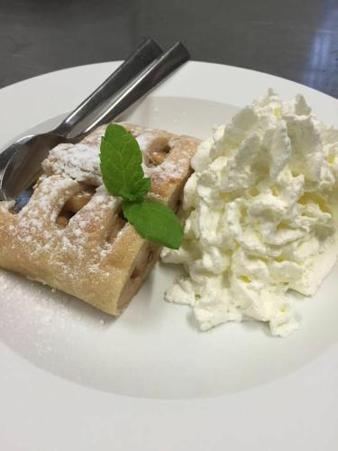 a white plate with a waffle and a side of cole slaw at Hotellerie Gasthaus Schubert in Garbsen
