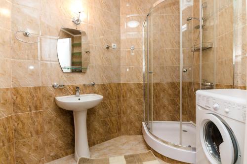a bathroom with a sink and a washing machine at Apartment in Cozy Little Yard in Tbilisi City