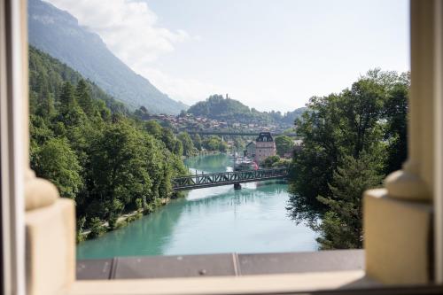 a view from a window of a river with a bridge at Grand Hotel Beau Rivage Interlaken in Interlaken