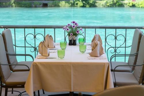 a table with a vase of flowers on it at Grand Hotel Beau Rivage Interlaken in Interlaken
