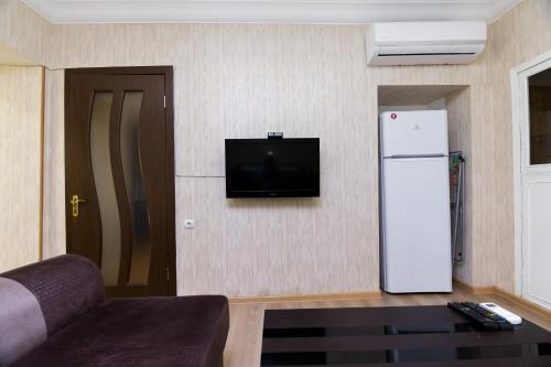 a living room with a refrigerator and a tv at Apartment in Cozy Little Yard in Tbilisi City