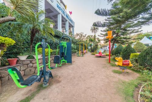 a playground in front of a building at Hotel Hillock in Mount Ābu