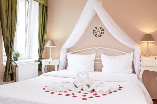 a bedroom with a bed with two towels and hearts at Amálka u Řípu in Straškov