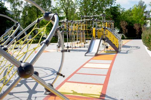 a row of playground equipment in a park at Hotel Aquarius SPA in Kołobrzeg