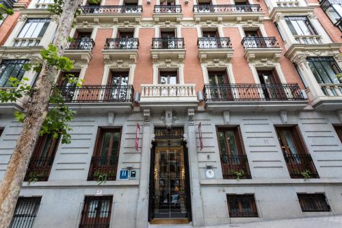 a building with balconies on the side of it at Petit Palace Lealtad Plaza in Madrid
