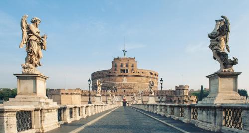 a bridge in front of a large building at Hotel dei Mellini in Rome