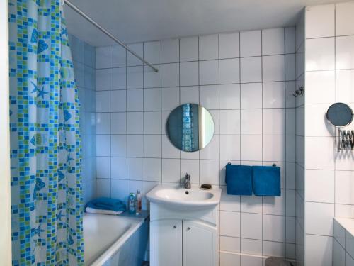 a white bathroom with a sink and a mirror at K8 in Liepāja