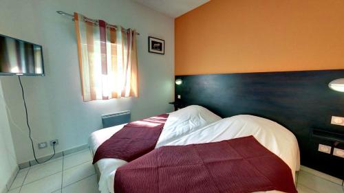a hotel room with two beds in a room at Village Vacances Passion Le Cezallier in Ardes-sur-Couze