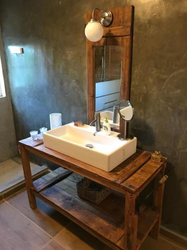 a bathroom with a white sink and a mirror at Azeite de Marvão, Olivoturismo casa Mestre do Lagar in Marvão