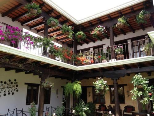 a building with lots of potted plants on the balconies at Hotel Casa Madeleine B&B & Spa in Antigua Guatemala