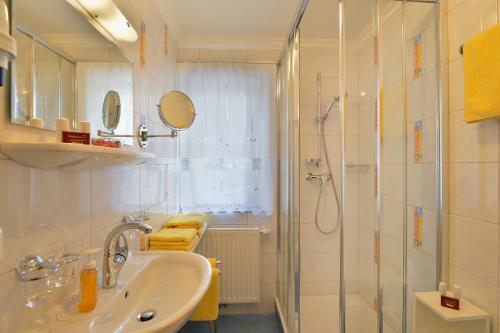 a bathroom with a sink and a shower at Haus Hammerer in Ellmau
