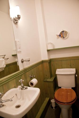 a bathroom with a toilet and a sink at The Charles Bathurst Inn in Richmond