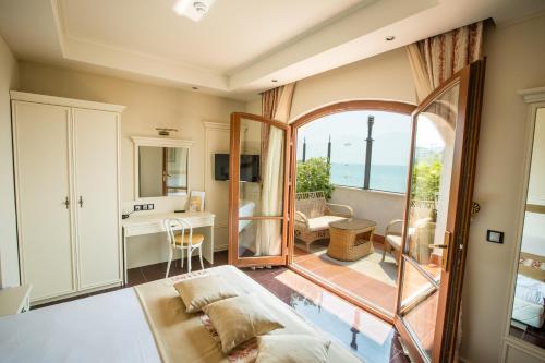 a bedroom with a bed and a view of the ocean at Helena VIP Villas and Suites - Half Board in Sunny Beach