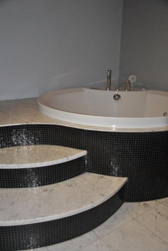 a bathroom with a bath tub and a sink at Casa Rattazzi in Turin