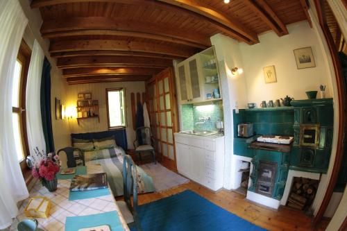a large room with a kitchen and a living room at Rosehill Cottage in Orbányosfa