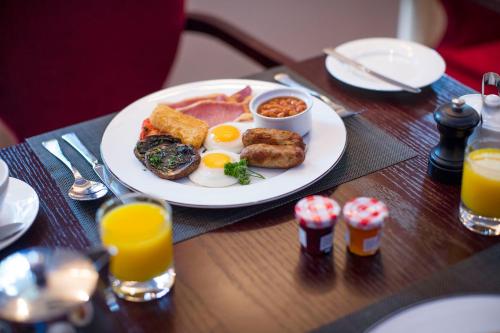a plate of breakfast food on a wooden table at The Royal Horseguards in London