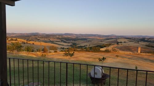 a view of a field from a balcony at Agriturismo Bio Aia della Colonna in Saturnia
