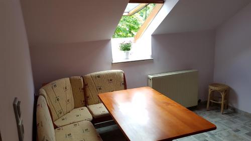 a room with a table and a chair and a window at Pension-Puttlachtal in Pottenstein