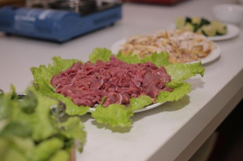 a plate of food on a counter with lettuce at Lao Cai Royal Hotel in Lao Cai