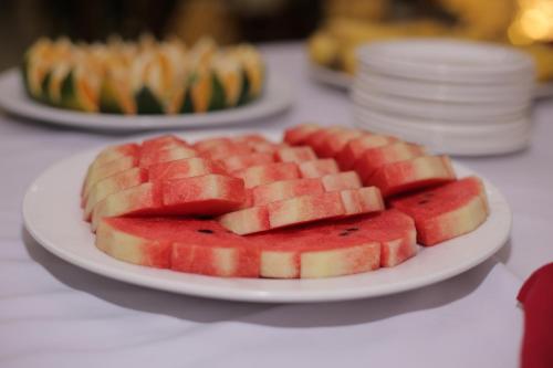 a plate of slices of watermelon on a table at Lao Cai Royal Hotel in Lao Cai
