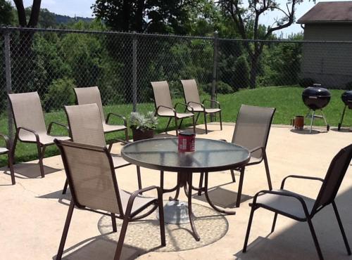 a group of chairs and a glass table and chairs at Ramada by Wyndham Catlettsburg Ashland in Catlettsburg
