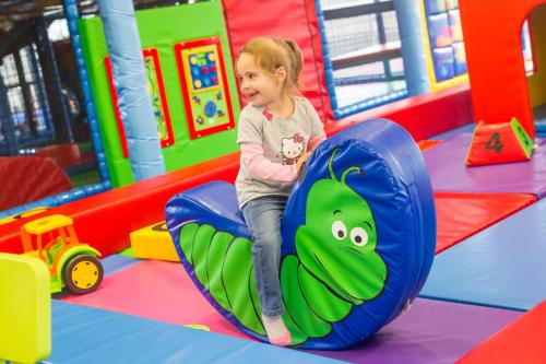 a little girl playing in an indoor play gym at Aquaticum Debrecen Termal & Wellness Hotel in Debrecen