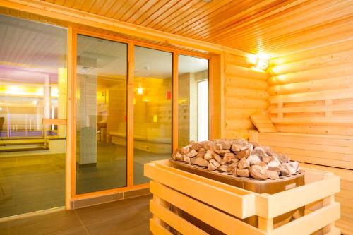 a log cabin with a pile of fire wood at Aquaticum Debrecen Termal & Wellness Hotel in Debrecen