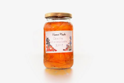 a jar of homemade tomato sauce with a label on it at Ammonite Lodge in Chard