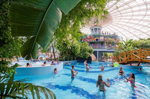 a group of people in a swimming pool at a theme park at Aquaticum Debrecen Termal & Wellness Hotel in Debrecen