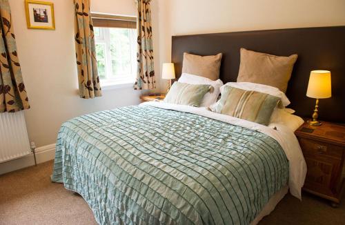 a bedroom with a large bed and a window at Claverton Hotel in Battle