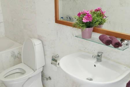 a bathroom with a sink and a toilet and a mirror at Larnaka Beach House 3 in Larnaka
