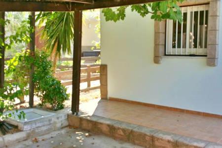 an outside view of a house with a porch at Larnaka Beach House 3 in Larnaka