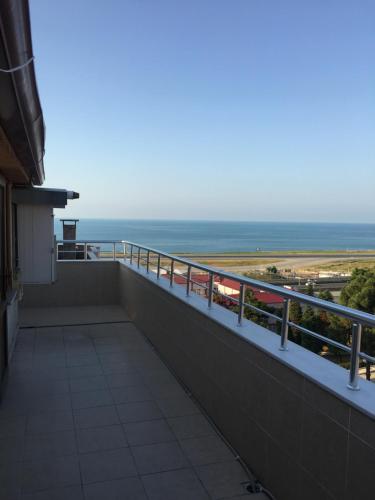 a balcony with a view of the ocean at YALI Suit HOTEL in Trabzon