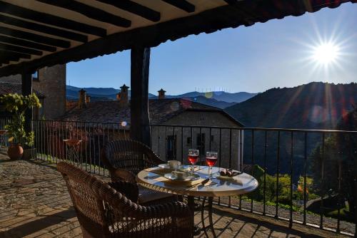 a table on a balcony with two glasses of wine at Parador de Sos del Rey Católico in Sos del Rey Católico