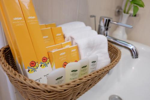 a basket filled with towels and toiletries on a sink at Na Na Ya Ji Bed and Breakfast in Taitung City