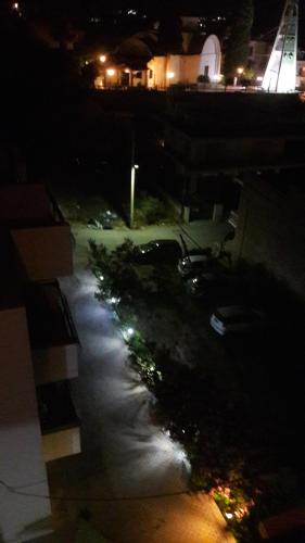 a view of a parking lot at night at Ntemos Apartments in Tolo
