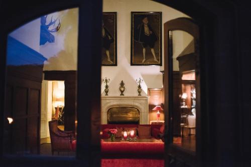 a living room with a fireplace and a fire place at Gästehaus Schloss Saareck in Mettlach