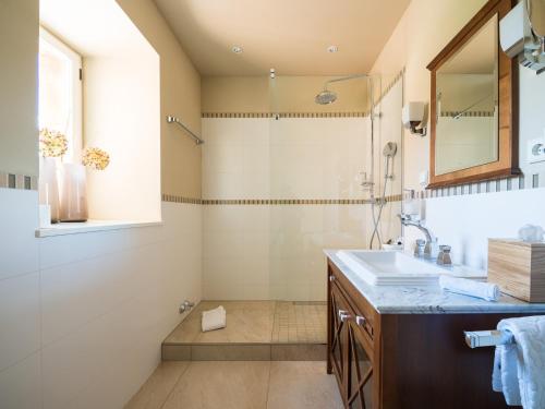 a bathroom with a sink and a shower at Gästehaus Schloss Saareck in Mettlach