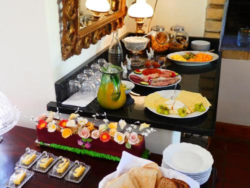 a buffet with food on a table with plates of food at Sorgvry - House of Guests in Barrydale