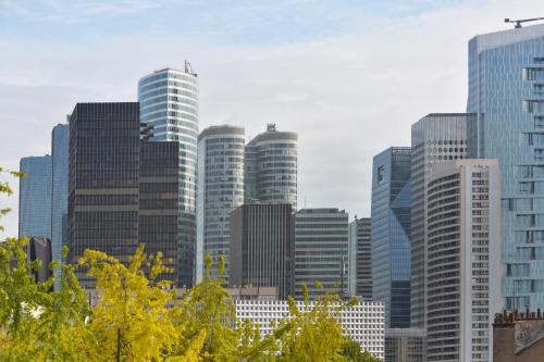 a group of tall buildings in a city at Hotel Douglas in Puteaux