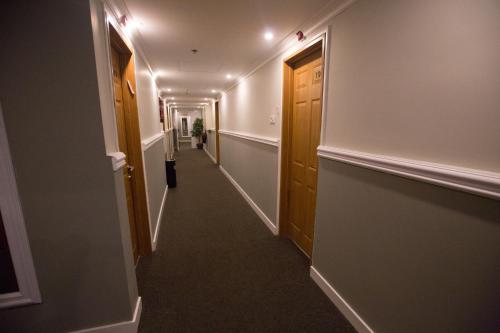 a hallway with two doors and a long corridor at Spat Beach in Bat Yam