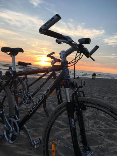 two bikes parked on the beach at sunset at Saulės Krantas in Palanga