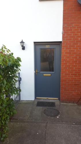 a blue door on the side of a building at Alexandra Park Town House 223 in Belfast