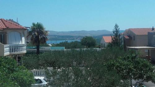 a view of a house with a bench in a yard at Apartment Jopa in Šibenik