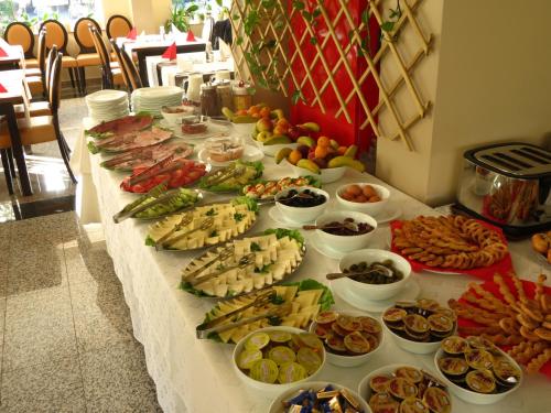a table with many different types of food on it at Hotel Crisalpin in Poiana Brasov