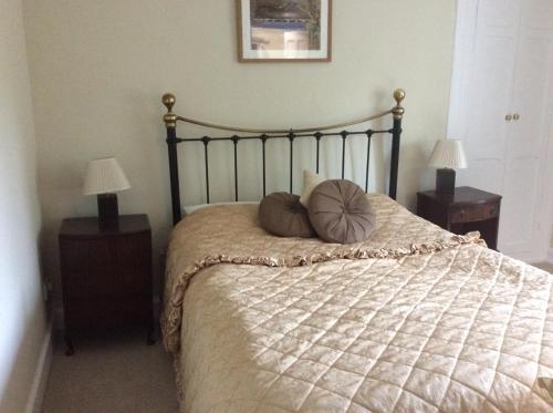 a bed with two pillows on it in a bedroom at Zeal Farm in Dulverton