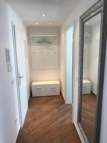 a mirror in a room with a dressing room at Ermmes Ferienwohnungen in Sinsheim