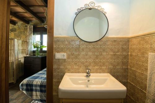 a bathroom with a sink and a mirror at La Vega del Prado in Tarifa