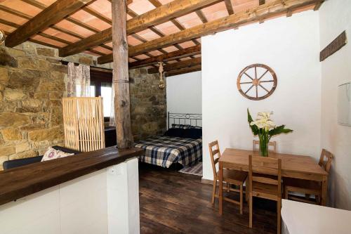 a living room with a table and a bedroom at La Vega del Prado in Tarifa