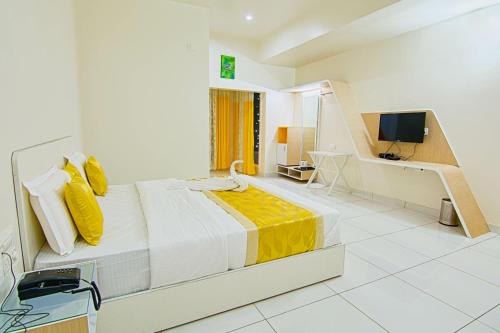 a bedroom with a large bed with yellow pillows at The Cocoon in Gonikoppal